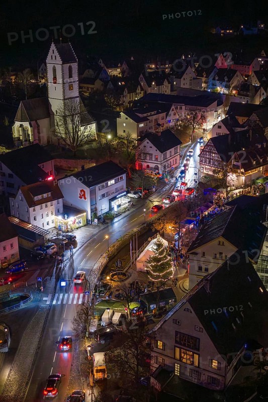 Aerial view of a festively lit village with Christmas lights and church, Aidlingen Christmas market, BÃ¶blingen district, Germany