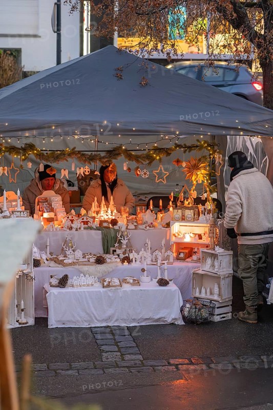 Detail of a Christmassy decorated market stand with candles and fairy lights in a tent, Aidlingen Christmas market, Böblingen district, Germany