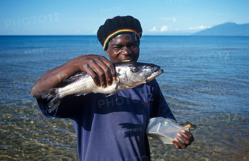 Man showing a big fish, Kande, Lake Malawi, Africa, July 2000, vintage, retro, old, historic