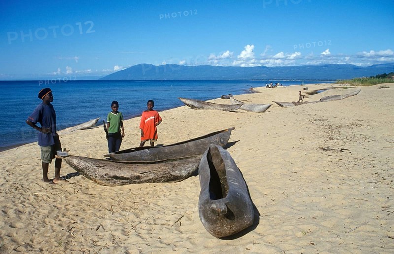 Local man and boy with canoes near Kande Beach on Lake Malawi, Malawi, Africa, July 2000, vintage, retro, old, historic