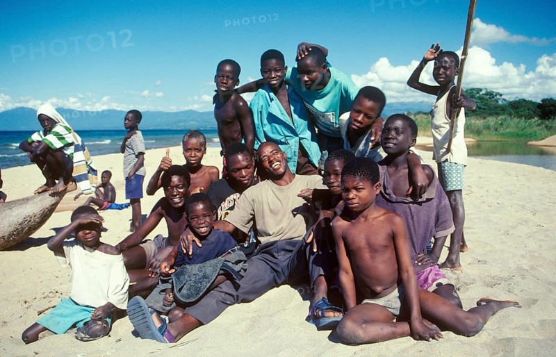 Boys and young men pose for a photo on Kande Beach on Lake Malawi, Malawi, Africa, July 2000, vintage, retro, old, historic