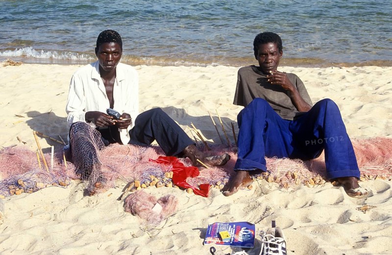 Fishermen at Kande Beach on Lake Malawi repair their nets, Malawi, Africa, July 2000, vintage, retro, old, historic