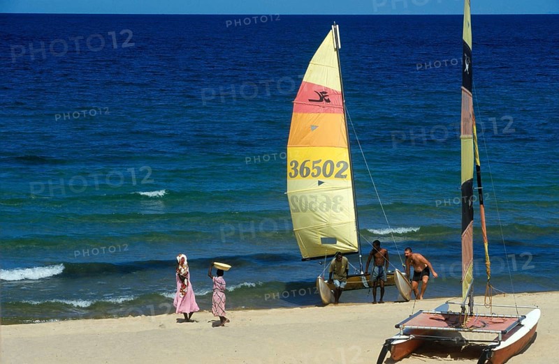 Local woman and tourist with catamaran on Lake Malawi, Kande, Malawi, Africa, July 2000, vintage, retro, old, historic