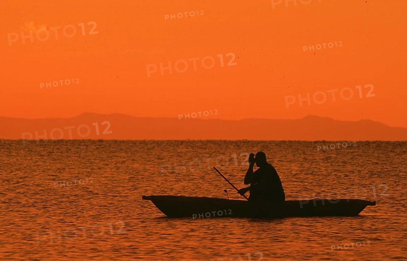 Sunrise over Lake Malawi, man in dugout, Kande, Malawi, Africa, July 2000, vintage, retro, old, historic