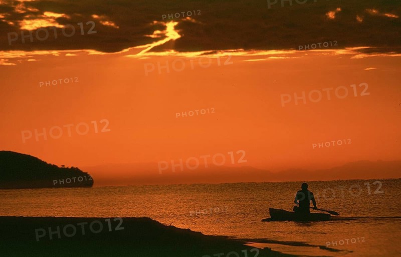 Sunrise over Lake Malawi near Kande, man in dugout, Kande, Malawi, Africa, July 2000, vintage, retro, old, historic