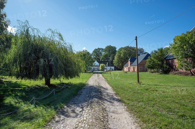 Old road to the old manor house, on the right the former horse stable from 1923, Gut Othenstorf, Mecklenburg-Western Pomerania, Germany