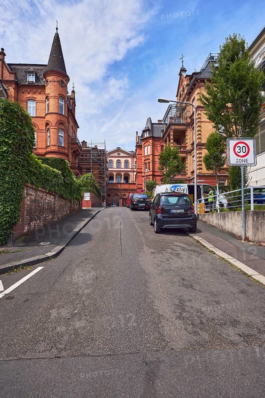 Houses, historic residential buildings, concrete wall, brick wall, trees, hedge, zone 30 sign, parking strips with vehicles, blue sky, cumulus clouds, street An der alten Synagoge, Wiesbaden, state capital, district-free city, Hesse, Germany
