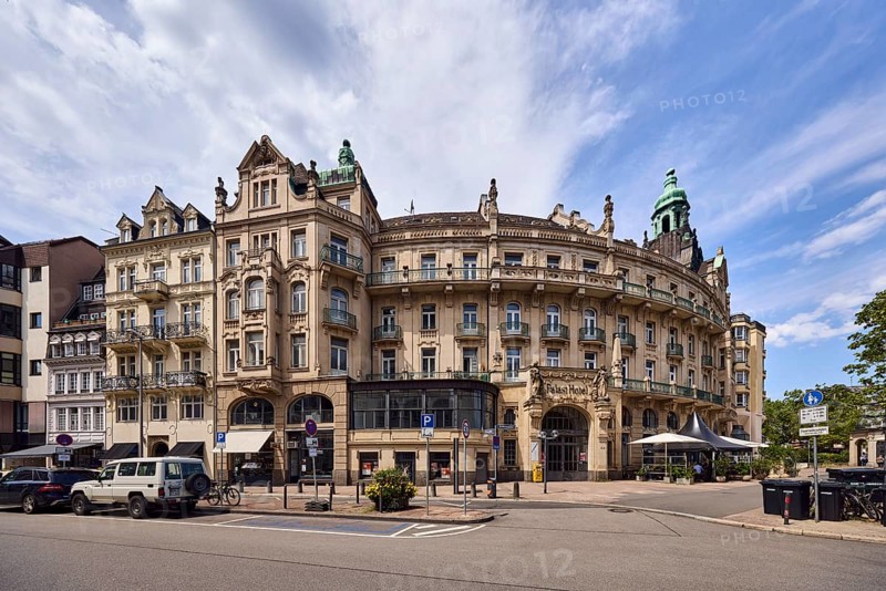 Historic building, former hotel palace hotel, barrier bollard, street, round faÃ§ade with windows, catering, outdoor area, restaurant, parking strip with vehicles, blue sky, cirrostratus clouds, cirrus clouds, cumulus clouds, wreath square, Wiesbaden, state capital, district-free city, Hesse, Germany