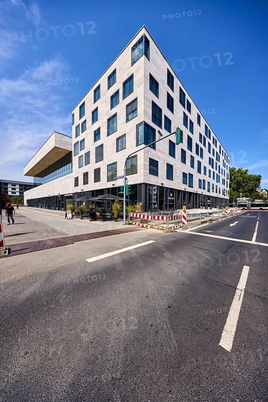 Pedestrian zone, road, lanes, road markings directional arrow, traffic light, commercial building, modern architecture, faÃ§ade with windows, fenced construction site, barrier, road construction, gastronomy Waffel House, trees, deep blue sky, cirrus clouds, intersection Schwalbacher StraÃŸe with German Unity Square, Wiesbaden, state capital, district-free city, Hesse, Germany