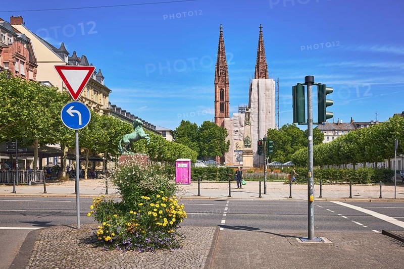 Traffic island, St. Boniface Catholic Church, barrier bollard, pedestrian crossing, traffic lights, traffic signs, right of way, prescribed direction of travel left, flower pots, general architecture, houses, scaffolding, renovation, trees, blue sky, cirrus clouds, RheinstraÃŸe, Luisenplatz, Wiesbaden, state capital, district-free city, Hesse, Germany