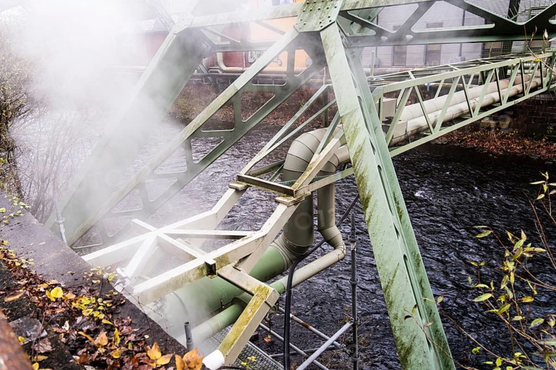 District heating pipeline over the Wupper river, steam escapes, Wuppertal, Germany