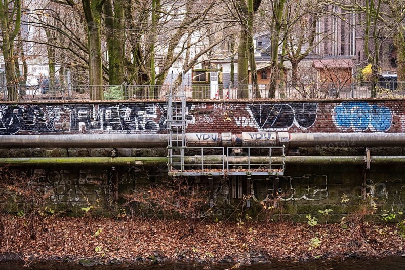 District heating pipeline in front of old industrial buildings on the banks of the Wupper, Wuppertal, Germany
