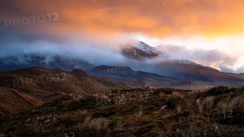 Volcanic landscape, Tama Lake Walk (Tama Lakes Track), Mt Ruapehu in clouds, evening light, sunset. Tongariro National Park, North Island, New Zealand