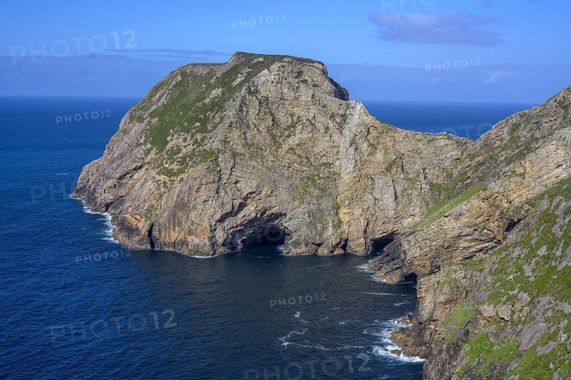 View of blue sea and cliffs with rock gate from Portacloy Loop Cliff Walk, Muingnabo, County Mayo, Ireland