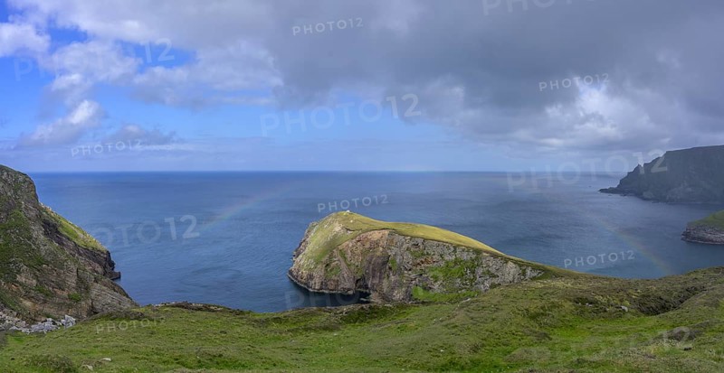 Rainbow over the blue sea and cliffs, Portacloy loop cliff walk, Muingnabo, County Mayo, Ireland
