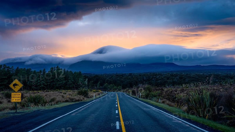 Mount Ngauruhoe in the morning at sunrise with glowing clouds, road SH 47. Tongariro National Park, North Island, New Zealand