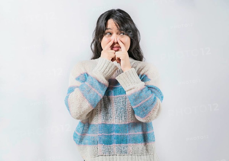 Asian woman with face of unpleasant odors, covering nose. Person covering nose because bad smells. Bad smells, Concept
