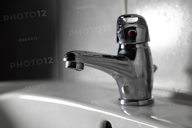 Modern chrome plated faucet in a bathroom