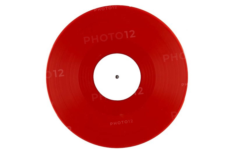 Red vinyl record with a white label in the middle on a white background