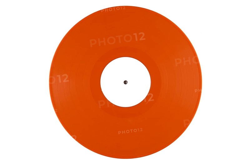Orange vinyl record with a white label in the middle on a white background