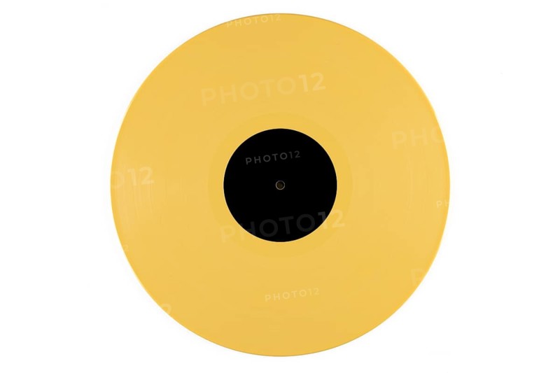 Yellow vinyl record with a black label in the middle on a white background
