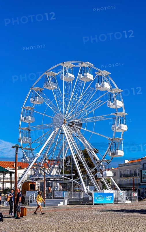Ferris wheel next to the holy church Santuario de Nossa in Nazare, Portugal