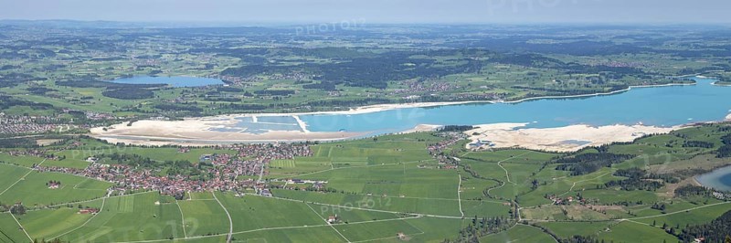 Panorama in spring from Tegelberg, 1881m, of Schwangau, Waltenhofen, Hopfensee and the partly still drained Forggensee, OstallgÃ¤u, Bavaria, Germany
