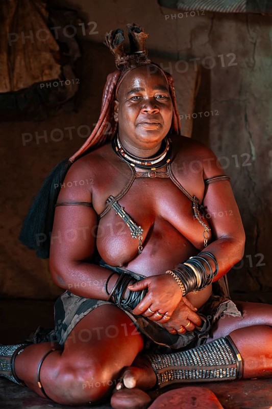 Elderly Himba woman in a hut, traditional Himba village, Kaokoveld, Kunene, Namibia