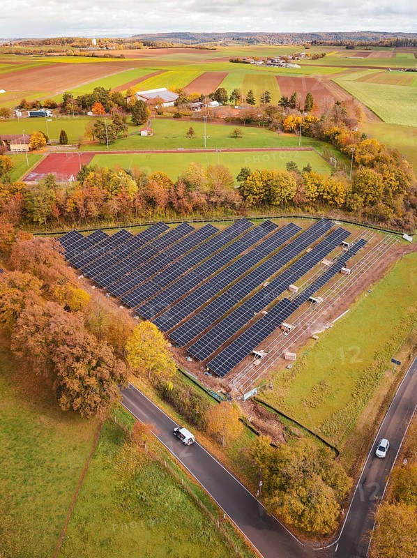 Solar systems in the middle of an autumnal landscape with a rural road, construction PV Freifaechenanlage, Weil der Stadt, Germany