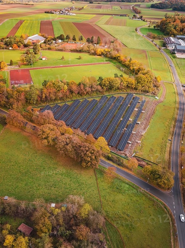 View of solar panels in rural area with roads and autumn trees, PV Freifaechenanlage construction, Weil der Stadt, Germany