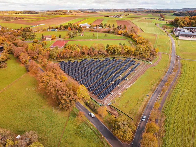 Panoramic view of solar panels surrounded by landscape characterized by autumn leaves, PV Freifaechenanlage building, Weil der Stadt, Germany