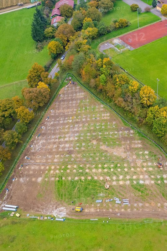 Parceled green area in triangle shape, surrounded by trees and infrastructural facilities, PV FreifÃ¤chenanlage construction, Weil der Stadt, Germany