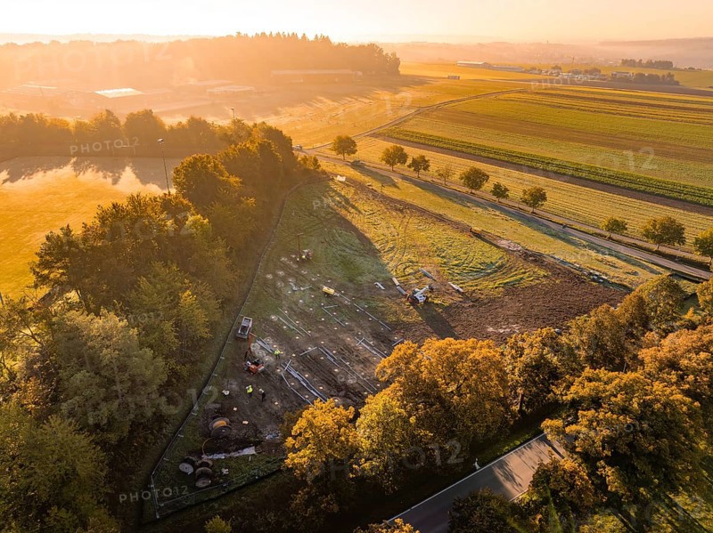 Morning landscape with warm lighting and trees next to construction, PV Freifaechenanlage construction, Weil der Stadt, Germany