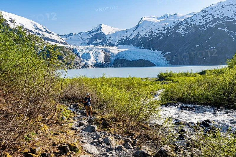 Hikers on the Portage Pass Trail, snowy mountains, Portage Glacier and Portage Lake, near Whittier, Alaska, USA