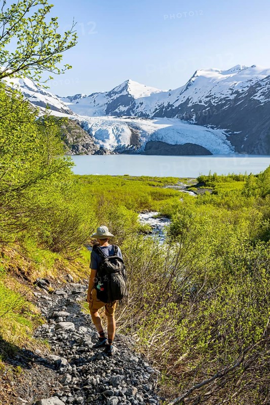 Hikers on the Portage Pass Trail, snowy mountains, Portage Glacier and Portage Lake, near Whittier, Alaska, USA