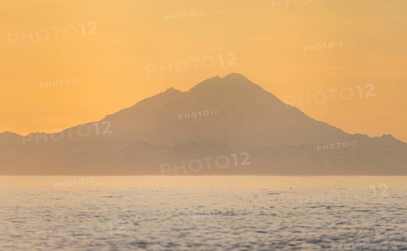 View of Cook Inlet on white mountain peaks of Mount Redoubt at sunset, midnight sun, Aleutian mountains, Anchor Point, Anchor River State Recreation Area, Alaska, USA
