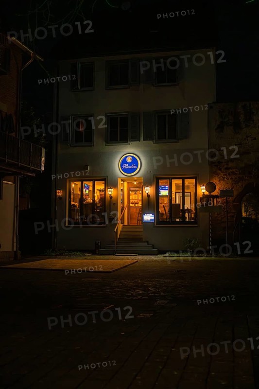 Inviting evening restaurant with illuminated windows and a sign, Sindelfingen, Böblingen district, Germany