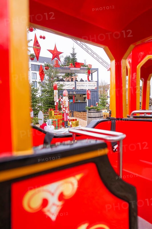 Red train at a Christmas market with festive decorations and fir trees in the background, Sindelfingen, Böblingen district, Germany