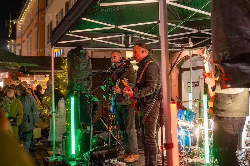 Live music performance on a stage in a festively illuminated market, Christmas market 2025, Nagold, Black Forest, Calw district, Germany