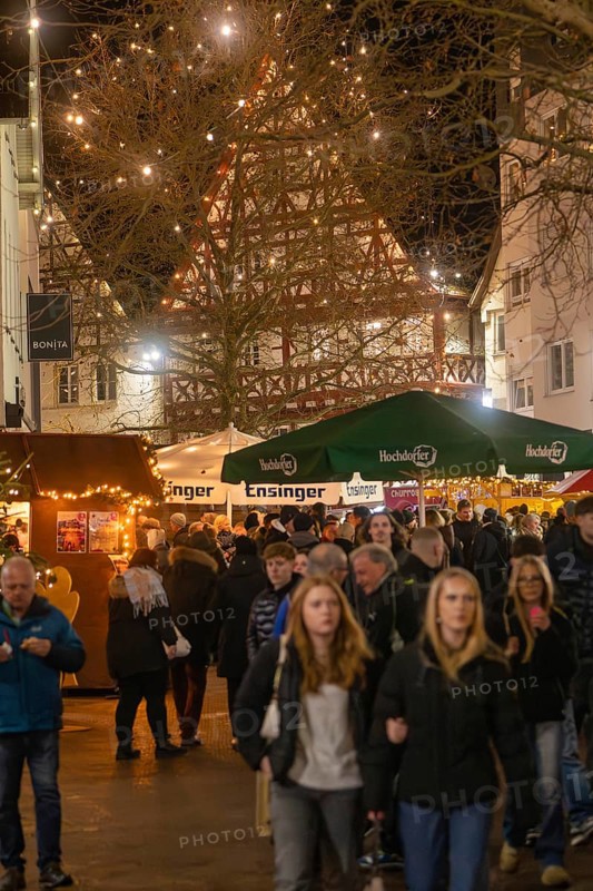 People stroll through a well-visited, festively lit Christmas market, Christmas market 2025, Nagold, Black Forest, Calw district, Germany