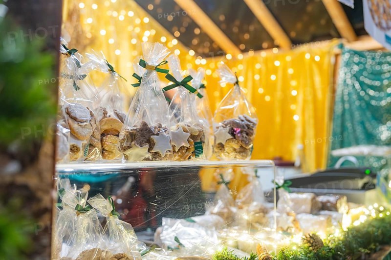 Packaged pastries on a Christmas market stand under twinkling lights, Christmas market 2025, Nagold, Black Forest, Calw district, Germany