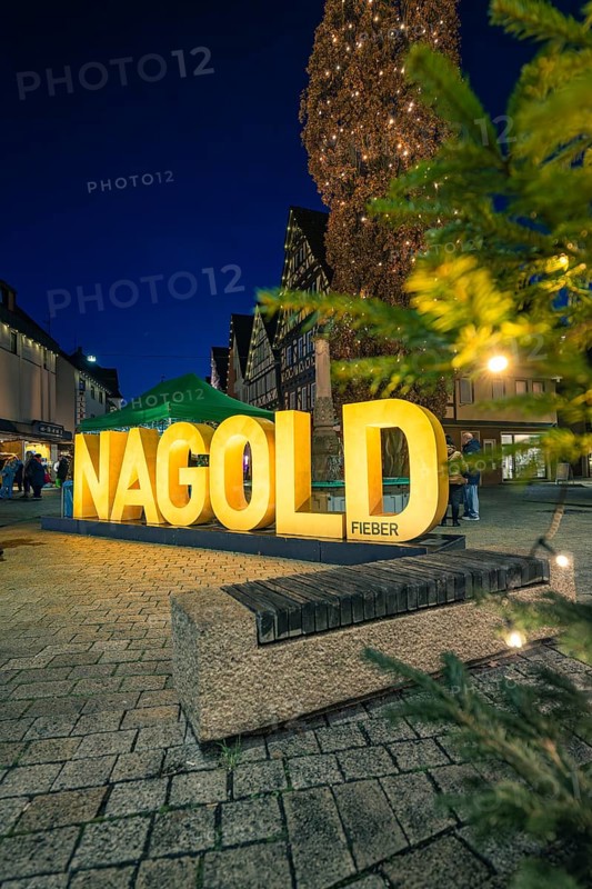 Glowing Nagold lettering and Christmas tree in the city center at night, Christmas market 2025, Nagold, Black Forest, Calw district, Germany