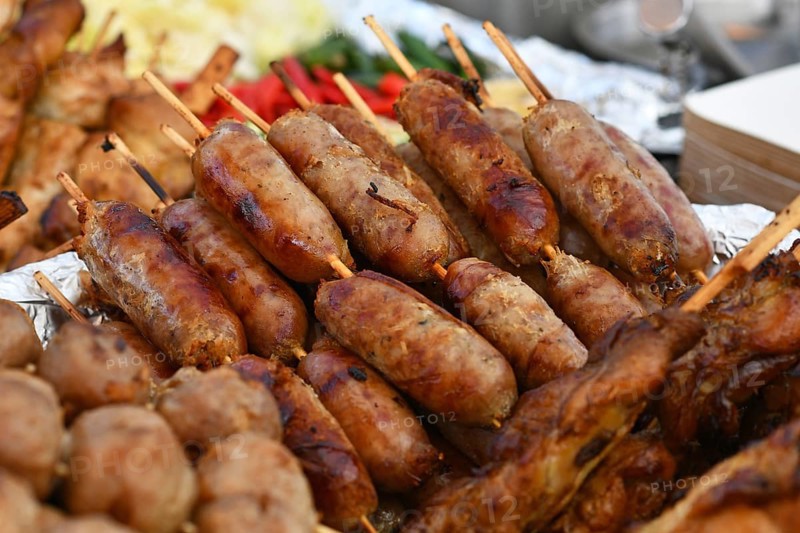 Thai 'Sai Krok Isaan' pork sausages on skewers at street food market