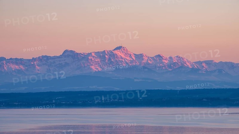 The Appenzell Alps, illuminated by the setting sun with the 2502 meter high SÃ¤ntis, in front of Lake Constance with the Swiss lakeside and Thurgauer SeerÃ¼cken, Lake Constance District, Baden-WÃ¼rttemberg, Germany