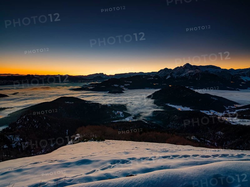 Alpine panorama at dawn in winter, fog in the valley, partly illuminated from below, Untersberg, Marktschellenberg, Berchtesgadener Land, Upper Bavaria, Bavaria, Germany