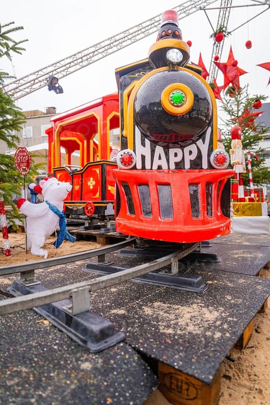 Red toy train with cheerful decoration on rails in a festive setting, Sindelfingen, Böblingen district, Germany