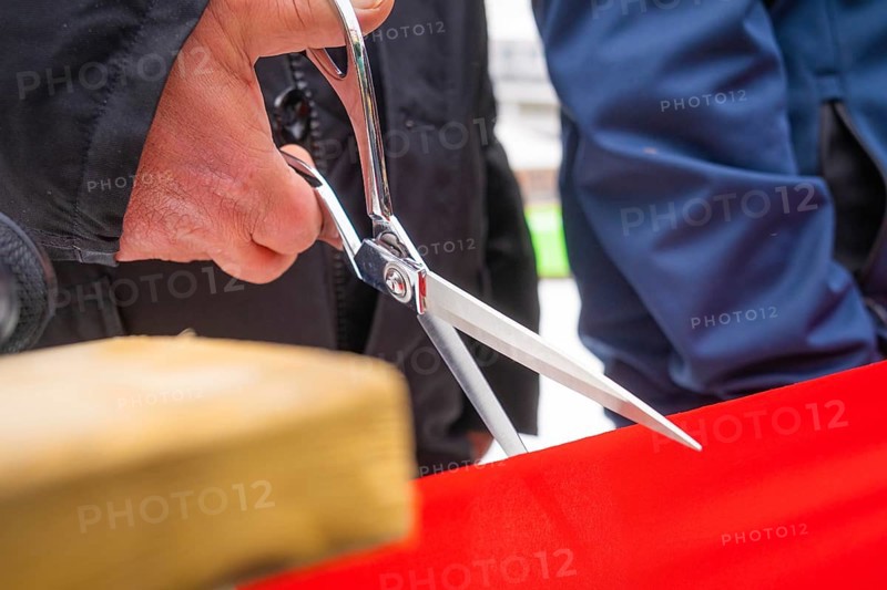 Close-up of scissors cutting a red ribbon at an opening ceremony, Sindelfingen, Böblingen district, Germany