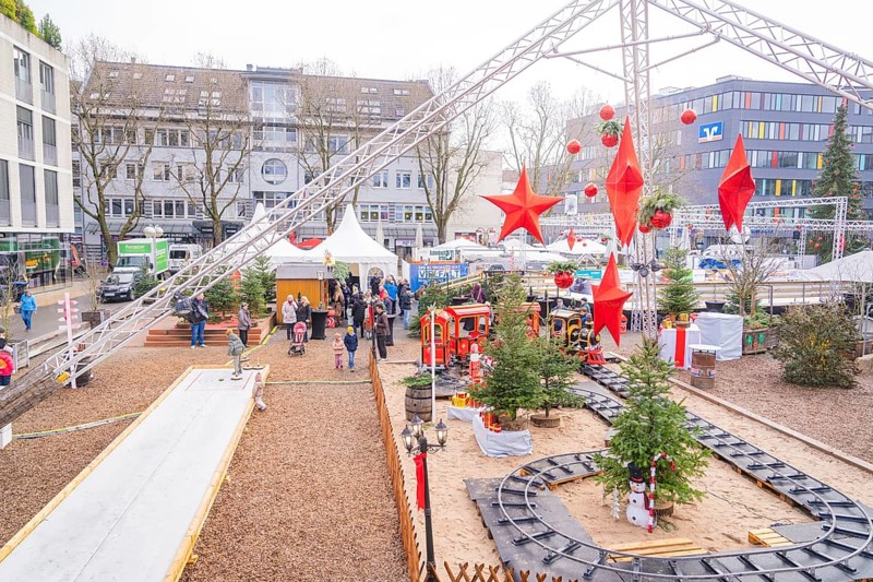 Christmas market with decorations and a toy train surrounded by visitors, Sindelfingen, Böblingen district, Germany