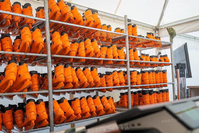 Shelves full of orange boots in a tent or storage room, Sindelfingen, Böblingen district, Germany