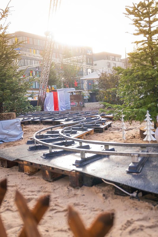 Curvy railroad tracks on Christmas market with sunlight in the background, Sindelfingen, Böblingen district, Germany
